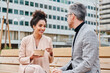 © IVAN GENER/Stocksy - Businesspeople talking over lunch outside