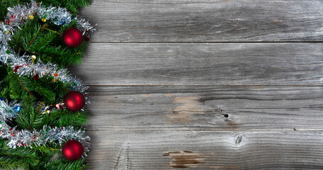 Wall Mural - Merry Christmas and Happy New Year holiday theme with silver tinsel and red ball ornaments on wood