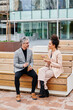 © IVAN GENER/Stocksy - Businesspeople talking outside at lunch