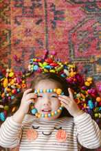 Little Girl Playing With Beads