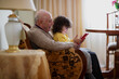 © BIG BLUE PRODUCTIONS SINGLE MEMBER PC - VAT 801021892/Stocksy - 2 year old boy with his grandfather using a digital tablet