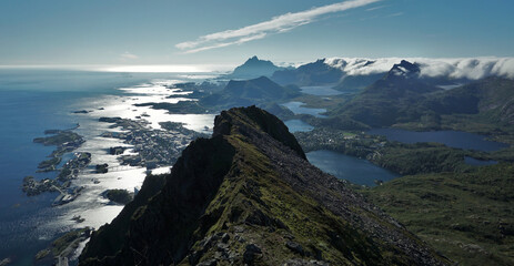 View over the beautiful city Svolvaer by the sea aswell as the surrounding lakes, fjords, and mountains on a sunny day at the Lofoten islands / Austvagoy / Norway