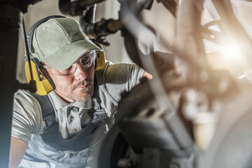 Wall Mural - Automotive Industry Technician Looking Into Engine Compartment