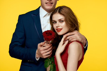 Gentlemen in classic suit on yellow background and red rose romance cropped view model portrait.