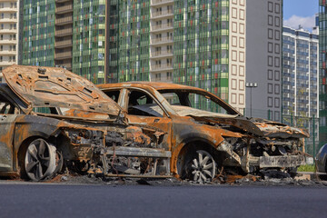 Wall Mural - city burned cars after a fire in one of the city's districts