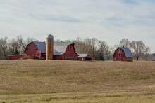 Farm And Red Barn In A Field