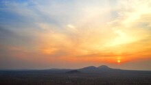 The Sun Rises Through Smoke And Haze Over The Mojave Desert In This Aerial Hyperlapse With A Bright Orange Dawn