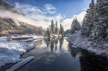 Wall Mural - Beautiful winter river landscape with reflection. The sun illuminates the forested shores. Wenatchee river area, Washington, USA