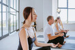 © lithiumphoto - Young woman in yoga class meditating with closed eyes