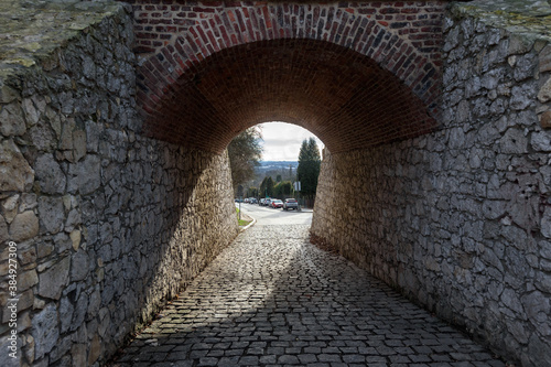 Fotomural Arched stone passage under bridge on city street in Krakow, Poland