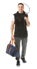 Wall Mural - Sporty young man with bag and tennis racket on white background