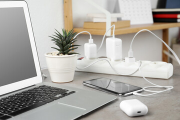Smartphone charging with cable on light stone table