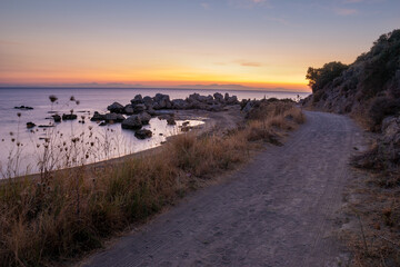 Wall Mural - dirt road over the aegean sea during sunrise