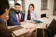 © Mediteraneo - Meeting with agent in office, buying renting apartment or house, buyers of real estate ready to conclude a deal.