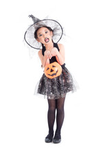 Full Length Of Asian Girl In Halloween Costume Holding Pumpkin Bucket Over White Background.