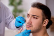 © Elnur - Young man visiting experienced doctor dermatologist