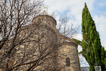 Orthodox church in Jvari Monastery located near Mtskheta, Georgia. Old house built of yellow stones and bricks.