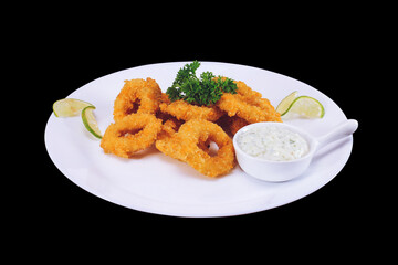 Wall Mural - Fried squid or octopus (calamari) with sauce isolated against a background of dark. Top view.
