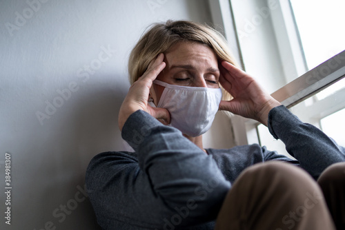 Fototapeta Woman indoors at home feeling stressed, mental health and coronavirus concept.