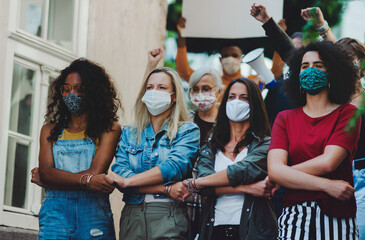 Wall Mural - Group of people activists protesting on streets, women march, demonstration and coronavirus concept.