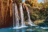 Fototapeta Kwiaty - The upper Dyuden waterfall is a unique natural wonder not far from the center of Antalya. Golden soft light in early autumn in Turkey
