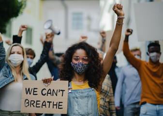 Wall Mural - Group of people activists protesting on streets, BLM demonstration and coronavirus concept.