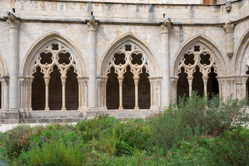 horizontal front view of gothic arches from the cloister garden of the poblet monastery, tarragona, 