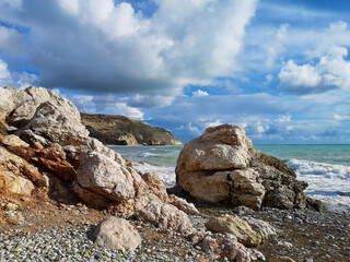 Petra tou Roumiou beach and a restless Mediterranean Sea.