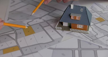 Wall Mural - people discussing and choosing building plot for house construction on cadastral map