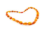 Fototapeta Do pokoju - beautiful beads of amber lying in the form of a heart