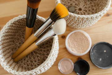 makeup brushes in the basket and face powder