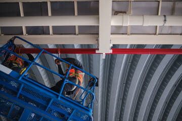 Wall Mural - Install fire sprinkler system. In the industrial plant, pipe assembly, red fire pipe, fire protection contractors Using Scissor Lift High work