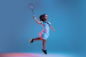 Wall Mural - Action. Beautiful dwarf woman practicing in badminton isolated on blue background in neon light. Lifestyle of inclusive people, diversity and equility. Sport, activity and movement. Copyspace for ad.