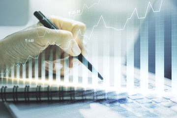 Abstract creative financial graph with hand writing in diary on background, financial and trading concept. Multiexposure