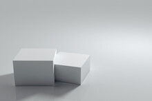 A Pedestal For Subject Shooting In The Form Of Two Cubes: A Larger And A Smaller One. Gray Background For Subject Placement. 3D Rendering.