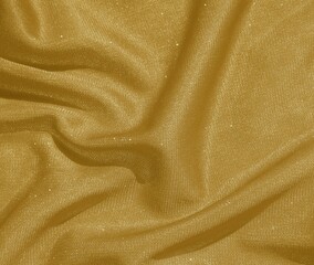 Shiny gold crumpled fabric. Wavy cloth background
