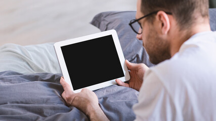 Aufkleber - Man Using Digital Tablet With Empty Screen Lying In Bed