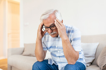 Wall Mural - Attack of the monster migraine. Unhappy Retired Senior man holding his head with pain expression . Face of senior man suffering from headache