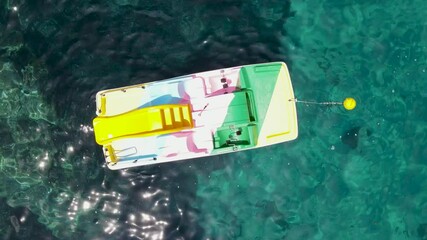 Wall Mural - Colourful Pedal Boat on the shoreline. Overhead aerial view from drone