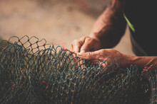 Selective Focus On Fisherman's Hand, Repairing Fishing Net
