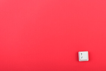 Poster - Keyboard key with question mark isolated. White keyboard key on red background. Top view. Close up