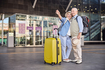 Joyous tourist showing something to her husband