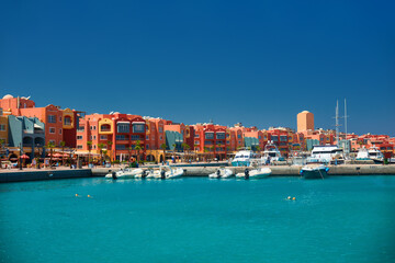 panoramic seascape on colorful marina promenade street from red sea with moored motor yachts. marina