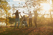 © Dann - Disabled teen boy playing in Fall leaves with a multi ethnic group of friends.
