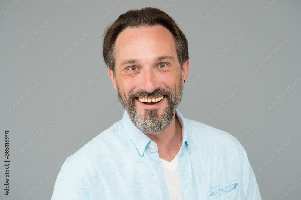 Happy mature man with healthy teeth and unshaven bearded face smile grey background, dental - obrazy, fototapety, plakaty 