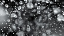 Explosion Of Water Droplets Into The Camera In Slow Motion On An Isolated Black Background