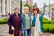 © grigvovan - Three senior women on a crowded street in a European city in cloudy weather.