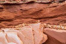 Red And Turquoise  Sedimentary Sandstone Cliff And Rocks At Cavendish Beach Of Prince Edward Island