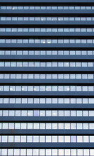 Full Frame Image Of A Large Commercial Office Building With Repeating Rows Of Geometric Windows