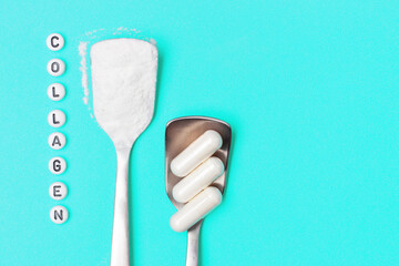 Two spoons of collagen and capsules on blue background copy space.